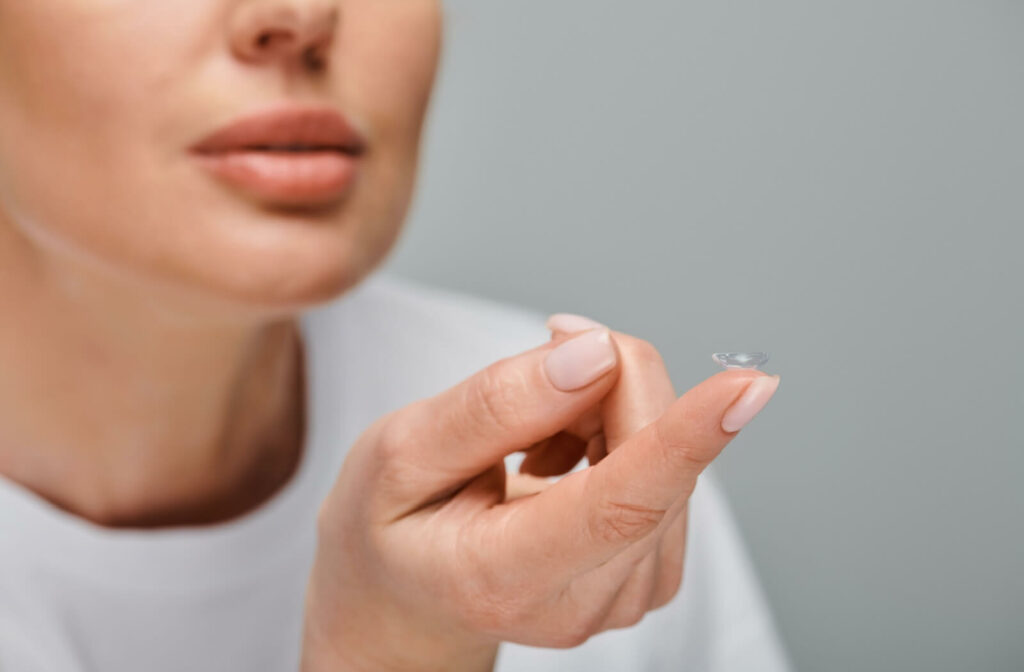 Someone holds a contact lens, about to put it in their eye.