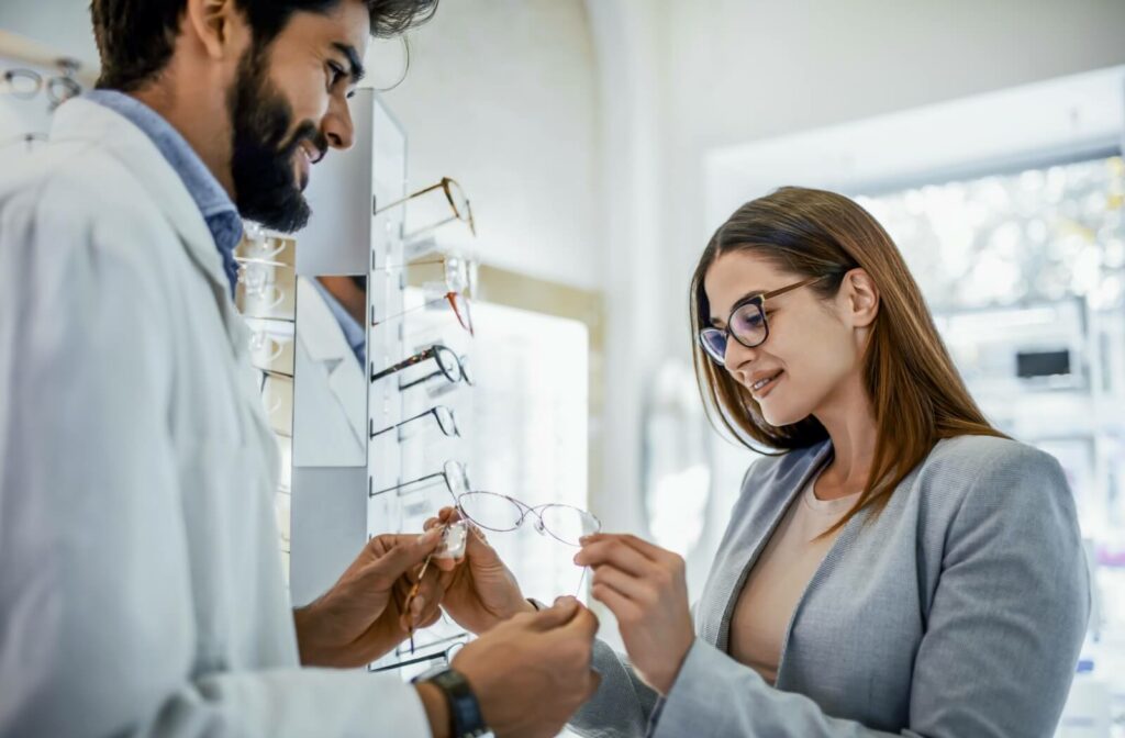 An optometrist helps a patient select a new pair of eyeglasses.